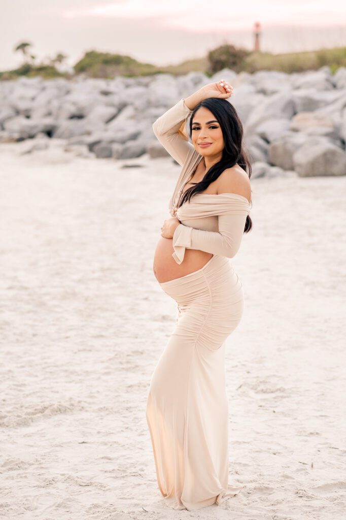 Maternity session at beach in Orlando, posing looking stright at the camera.